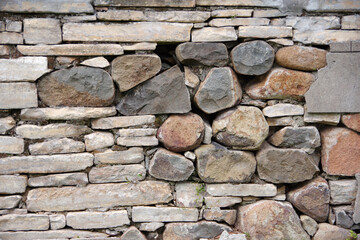 Close-up partial view of an old deteriorating stone wall
