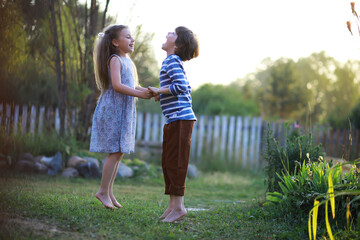 Children walk in the summer in nature. Child on a sunny spring morning in the park. Traveling with children.