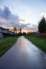 Fraser Heights, Surrey, Greater Vancouver, BC, Canada. Path in the Residential Neighborhood during a colorful spring season. Colorful Sunset Sky.