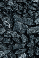 Rock or stone on the concrete wall in dark tone or black and white color.