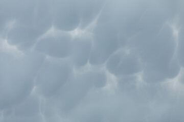Close-up view of storm clouds billowing in the sky. An overcast sky.