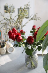 Bouquet of red roses on the table in the interior