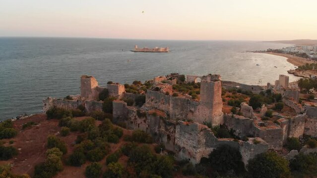 Aerial approach view Antik kiz kalesi fortification walls close-up in Kizkalesi turkish coast in summer