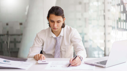 Business concept, Businessman checking financial graph on document and analyze to make report