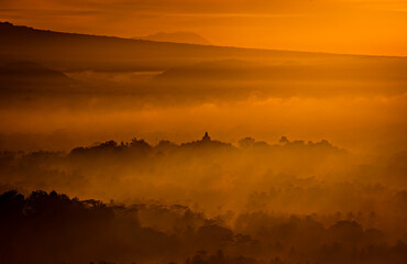 The mighty Borobudur Temple view in the morning from Puthuk Setumbu Hills in Magelang, Jogja, Indonesia