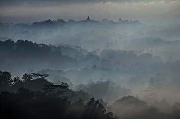 The mighty Borobudur Temple view in the morning from Puthuk Setumbu Hills in Magelang, Jogja, Indonesia
