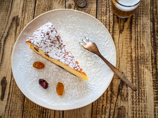 Cheesecake with raisins on wooden table