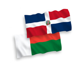National vector fabric wave flags of Dominican Republic and Madagascar isolated on white background. 1 to 2 proportion.