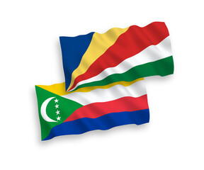 National vector fabric wave flags of Union of the Comoros and Seychelles isolated on white background. 1 to 2 proportion.