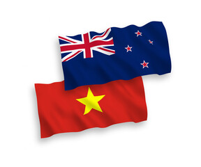 National vector fabric wave flags of New Zealand and Vietnam isolated on white background. 1 to 2 proportion.