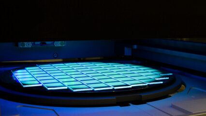 Silicon wafer with chips in UV lighting. Neon. Ultraviolet Lithography. - obrazy, fototapety, plakaty