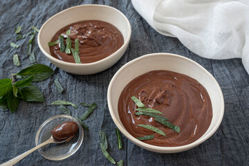 Chocolate cream in bowls with oranges and mint leaves