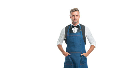 Fototapeta premium Serious chief cook keeping hands in chef apron pockets isolated on white, copy space