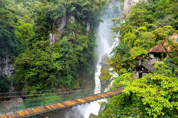 Fototapety  El Pailon del Diablo waterfall cascade and suspended bridge. Aerial view. Banos Santa Agua, Ecuador. South America.