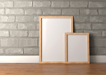 Two Beautiful wooden photo frames standing on floor against brick wall