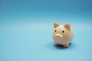 Piggy bank with space copy on blue background