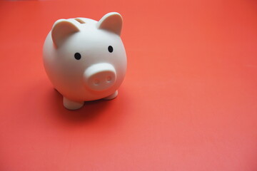 Piggy bank with space copy on red background