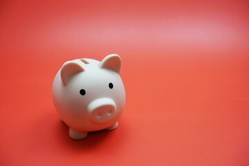 Piggy bank with space copy on red background