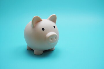 Piggy Bank Saving finance concept on blue background