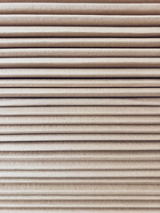 Side view of a corrugated cardboard. Cardboard boxes are folded on a pallet. Corrugated cardboard sheets are one by one.