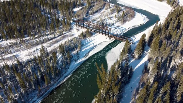 Aerial panorama view of Bow River valley forest in winter. Snowcapped Canadian Rockies mountain range beautiful scenery. Canmore Engine Bridge. Banff National Park. Alberta, Canada.