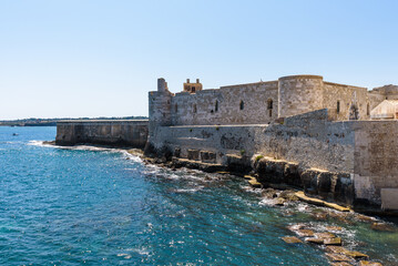 The Maniace Castle in the island of Ortigia. It was built during the Swabian period by Emperor Frederick II of Swabia. It features a decorated portal, arches, towers, a banquet room and a lighthouse.