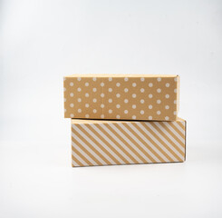 Two lovely closed stripes and polka dot pattern cardboard boxes taped up, the parcel box for delivery and shopping online concept design isolated on white background.