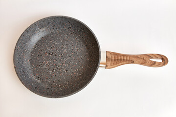 Quality frying pan made of cast iron alloy on a white background.