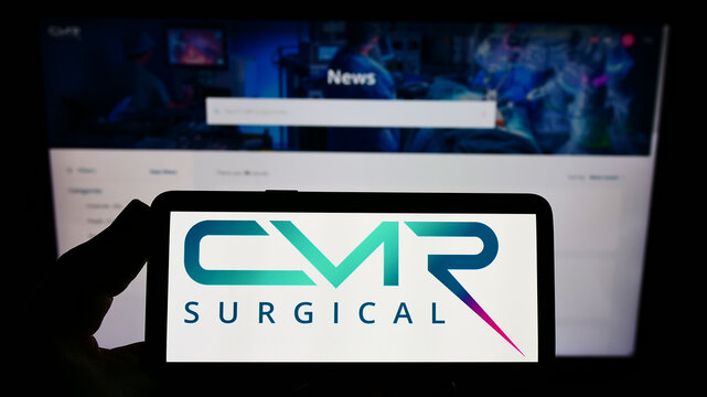 Stuttgart, Germany - 03-29-2022: Person holding smartphone with logo of medical technology company CMR Surgical Ltd. on screen in front of website. Focus on phone display.