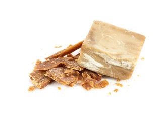 Pieces of old crumbled laundry soap. Isolated on white background.