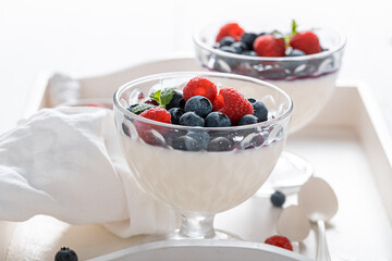 Fresh and tasty Panna Cotta with blueberries and raspberries jam.