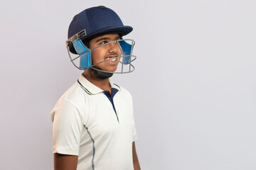 Portrait of boy wearing cricket Helmet looking elsewhere