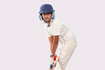 Portrait of boy getting ready to strike During a Cricket Game