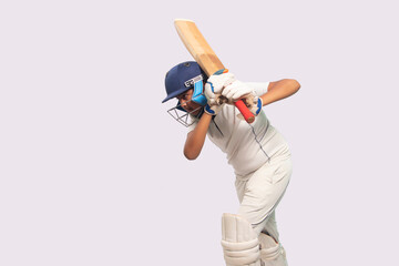 A boy in cricket uniform playing Cricket - obrazy, fototapety, plakaty
