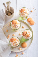 Fresh green jelly with peaches, sprinkles and cream.