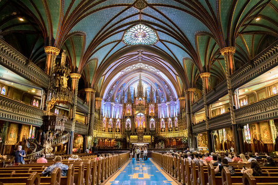 Interior of the Notre-Dame Basilica in the historic district of Old Montreal, showing the gothic revival main alter.