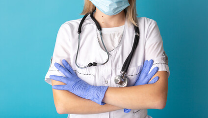 Close-up of a woman doctor with a stethoscope and protective gloves. Concept of professional clinical care, uniform and healthcare
