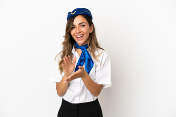 Airplane stewardess over isolated white background applauding after presentation in a conference