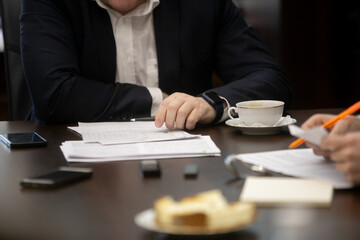 Fototapeta na wymiar Businessman signing a document after reading the agreement in office