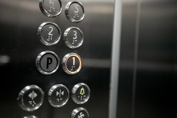 Floor buttons Elevator in an apartment residential building. Buttons of lift panel close-up. Movement, transportation concept. Lots of button on wall. Number on Elevators control panel is lit