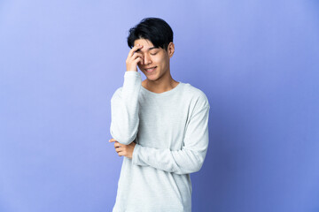 Young Chinese man isolated on purple background laughing