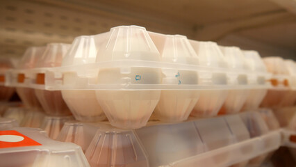 Fototapeta na wymiar Close-up of a beautiful plastic packaging of fresh eggs on a store shelf