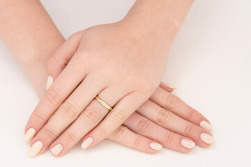 Golden Ring on a female hand, diamonds Diamond ring in hands of young lady. Close-up photo shoot