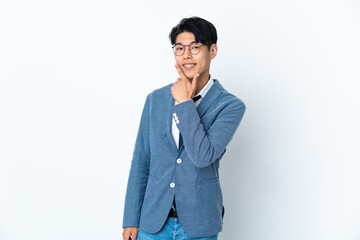 Young Chinese business man isolated on white background happy and smiling