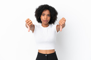 Young African American woman isolated on white background showing thumb down with two hands
