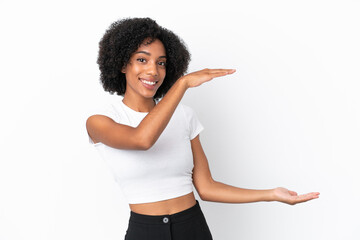 Young African American woman isolated on white background holding copyspace to insert an ad