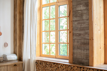 Big wooden window with frame and window sill and nature on background. Empty room, wooden window with with White linen curtain and logs decoration wall on a sunny day indoor shot. Scandinavian room - Powered by Adobe