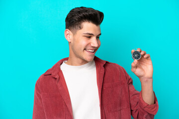 Young handsome caucasian man holding compass with happy expression