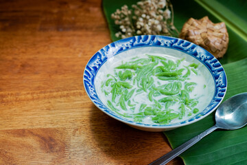 Lod Chong, Thai dessert, Lod Chong with coconut milk on a wooden floor. - obrazy, fototapety, plakaty