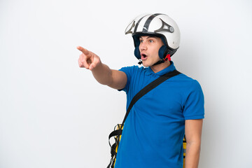 Young caucasian man with thermal backpack isolated on white background pointing away